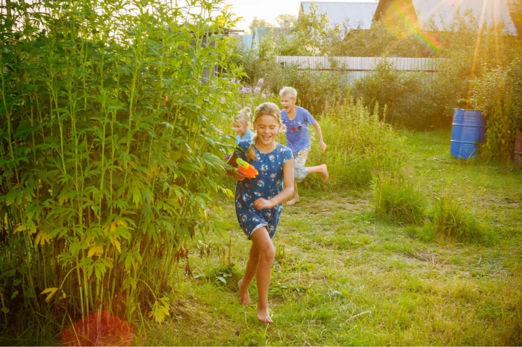 Three children enjoying a contented and peaceful life playing outside in a spacious garden thanks to the responsible financial stewardship of their grandparents.