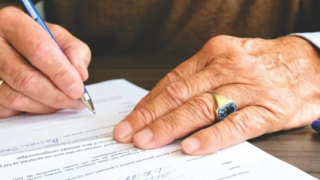 Elderly man writing documents needed for legacy planning