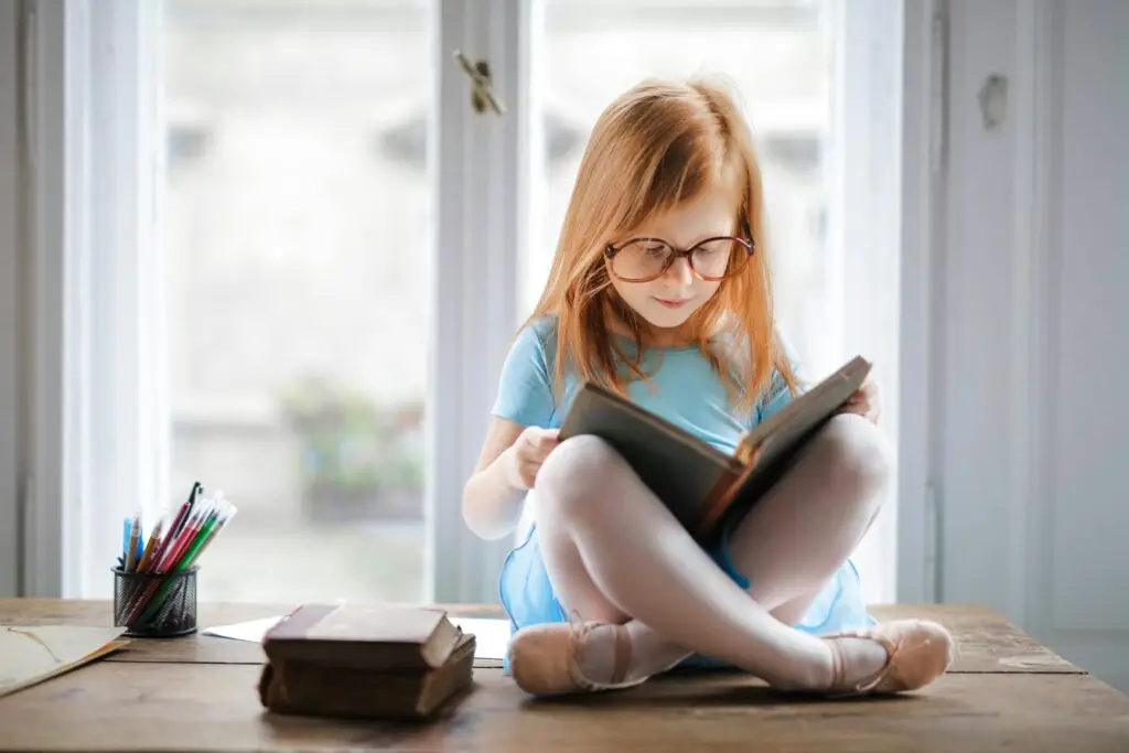 Young girl reading to show the importance of lifelong learning to financial discipline