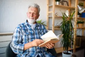Older man reading to discover the secret to financial discipline