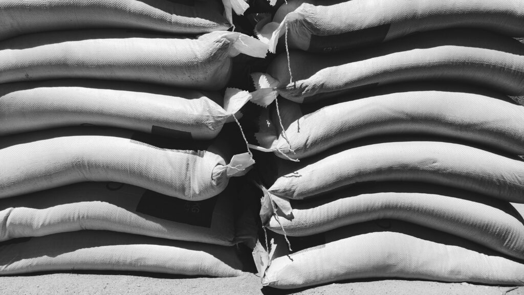 Two piles of sandbags represent the burden that debt can be, especially when just starting your career.
