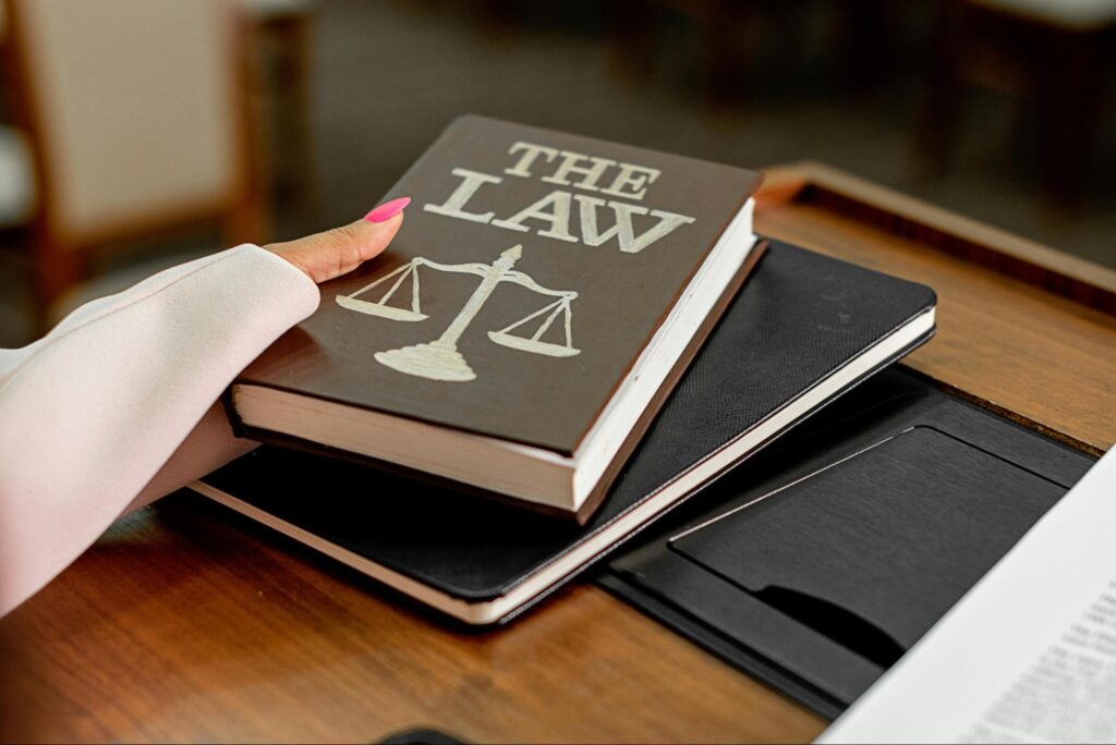 A photo of a law book represents how RIAs are bound to legal standards.