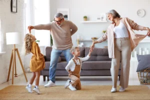 Grandparents dancing with grandchildren, trusting they are blessing them with a 529 plan while enjoying 529 plan tax benefits.