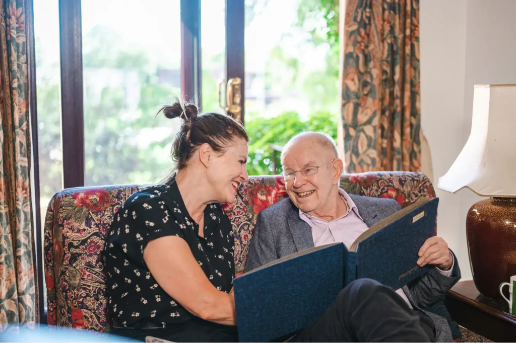 One important way to answer the question “How to invest for grandchildren” is to invest your presence as this grandfather is doing by showing his granddaughter old photographs.