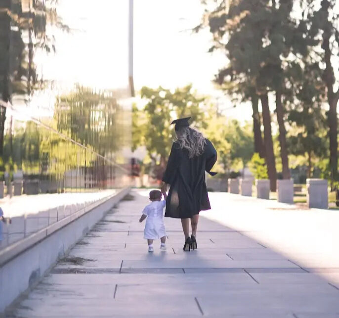 A woman who otherwise may not have been able to afford higher education enjoys graduation day with her son because years before her grandparents wondered about investment accounts for minors.
