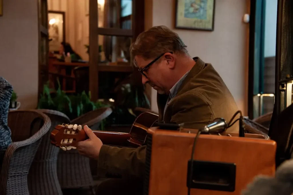A gentleman nearing retirement considers the relationship between inflation and retirement and its complexities as he plays the guitar.