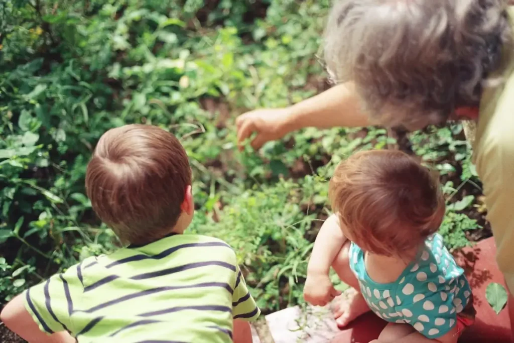 A grandmother who took time to think about how to account for inflation in retirement planning now enjoying retirement with her grandchildren by teaching them about her garden.