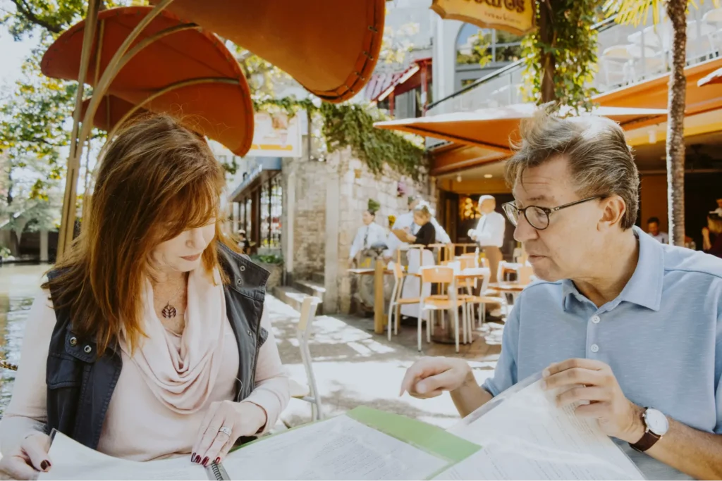 A pilot and his wife reviewing his pilot retirement plan together at their favorite restaurant.