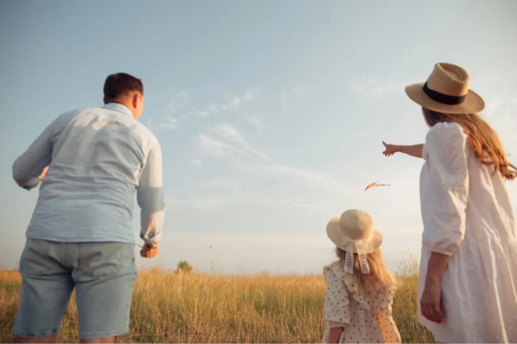 Pilot outside flying kites with family considering the airline pilot retirement age and next steps