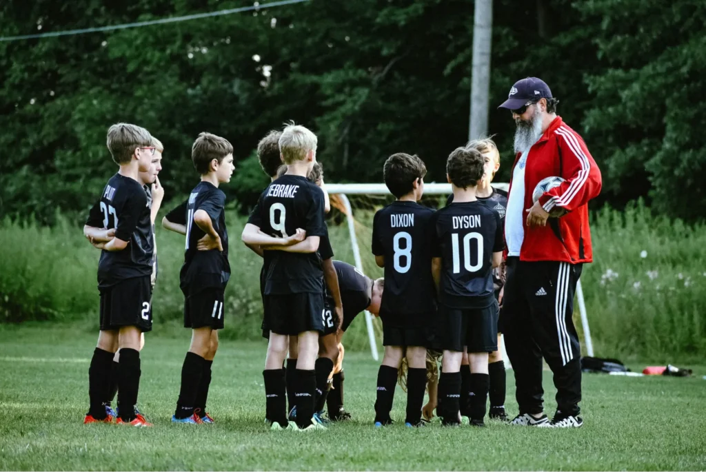 A pilot who is living out the answer to the question when do pilots have to retire is enjoying his retirement by coaching his grandson’s soccer team.