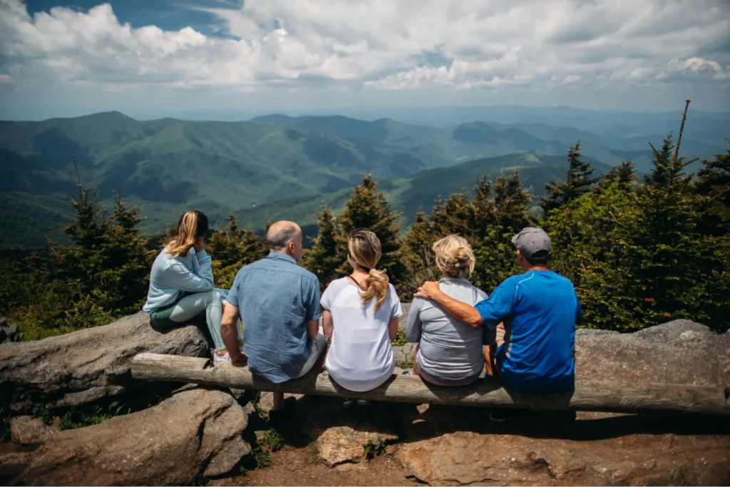 A multi-generational pilot family enjoying a mountain overlook together.